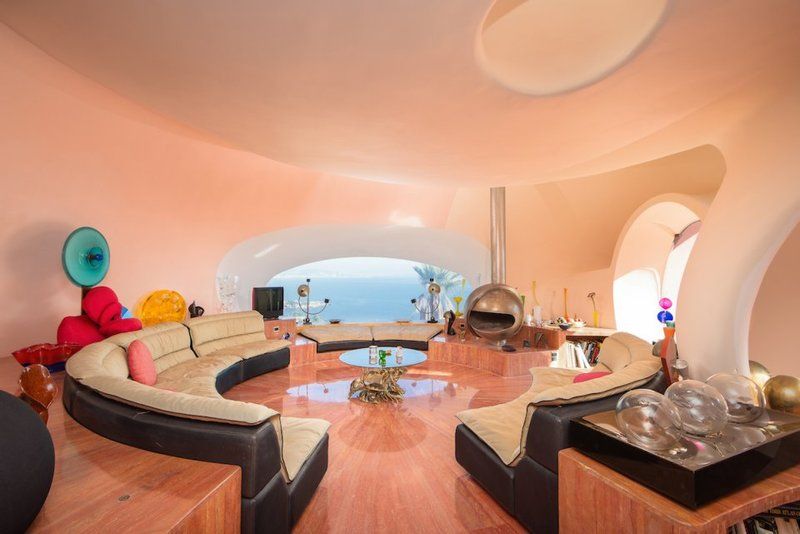 the-living-room-has-a-space-age-themed-decor-echoing-the-saucer-like-shape-of-the-bubbles-that-make-up-the-home-even-the-sofa-is-round.jpg