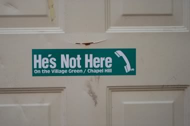 hes-not-here-on-the-village-green-chapel-hill-bumper-sticker.jpg